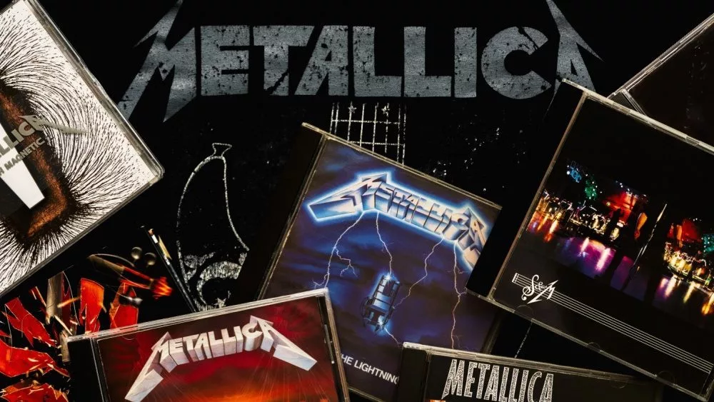 CDs of the heavy metal group Metallica over on a T-shirt with the Metallica logo. Illustrative editorial Leon-Spain-12 March 2024