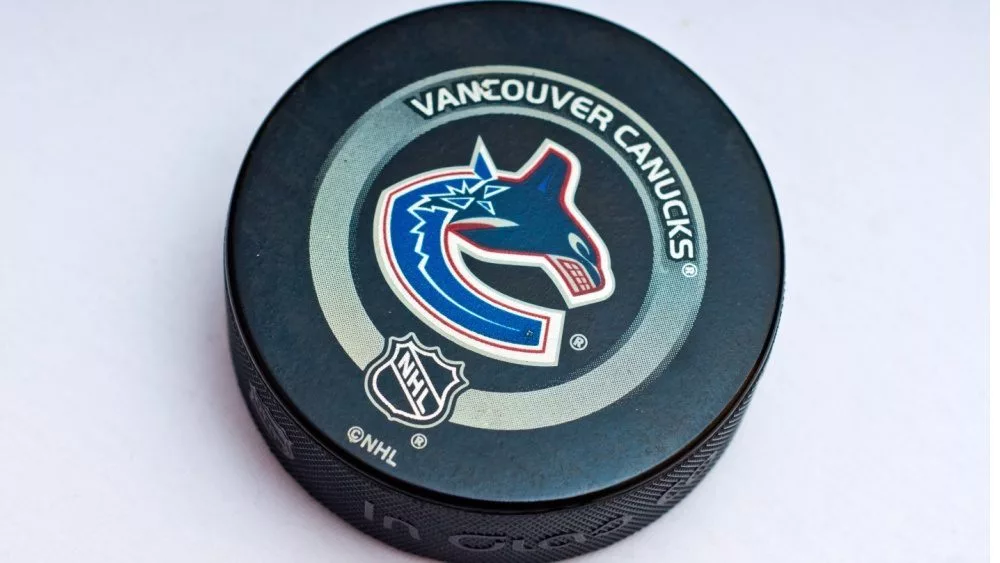 Official Vancouver Canucks game puck on the ice ^product shot