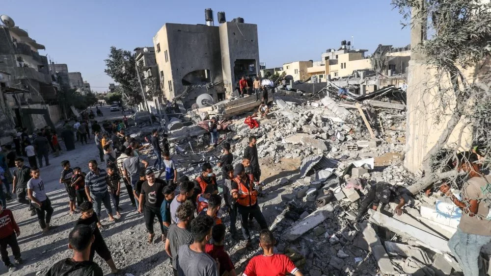 Palestinians evacuate wounded after an Israeli airstrike in Rafah refugee camp^ southern Gaza Strip^ on October 13 2023.