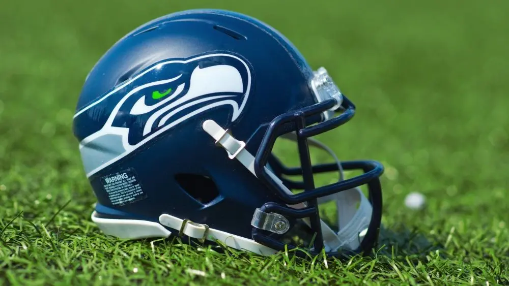 NFL Seattle Seahawks replica helmet on artificial grass playing turf ^ product shot