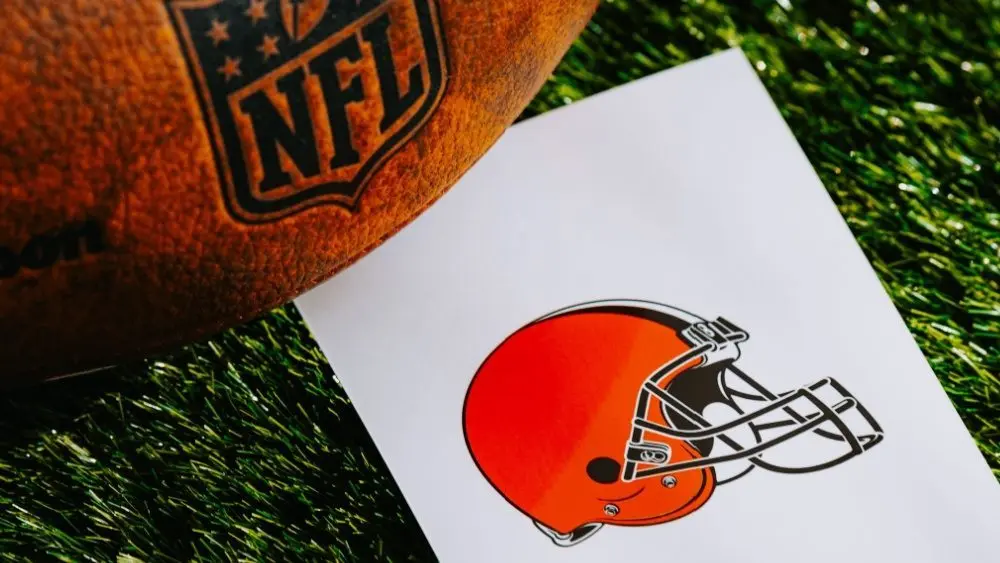 Cleveland Browns NFL team Logo and American football ball on Green Grass. CLEVELAND^ USA^ FEBRUARY 10^ 2025
