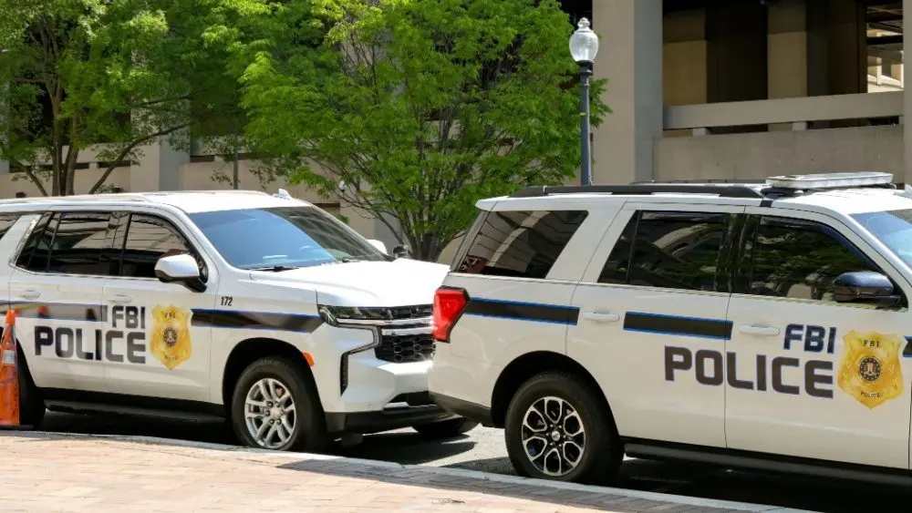 shutterstock_2462296779-1263712 Police patrol cars used by the FBI parked on a street outside the J Edgar Hoover headquarters building in downtown Washington DC. Washington DC^ USA - 30 April 2024