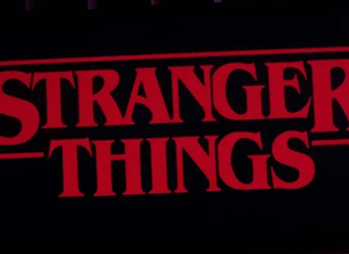 Iphone 11 pro with the Stranger Things logo on top of a computer keyboard. United States^ New York. Sunday^ September 29^ 2019.