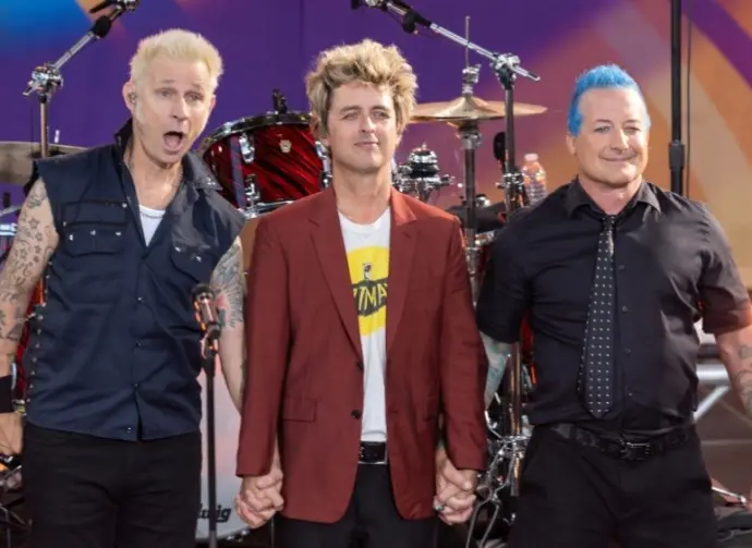 Mike Dirnt^ Billie Joe Armstrong^ Tre Cool pose on stage during ABC Good Morning America rock group Green Day concert in Central Park in New York on July 26^ 2024