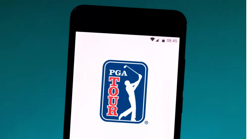 photo illustration the PGA Tour logo is displayed on a smartphone.