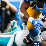 Dolphins linebacker Jerome Baker (55) tackled by Los Angeles Chargers running back Austin Ekeler (30) during an game^ Sept. 10^ 2023^ in Inglewood^ Calif.