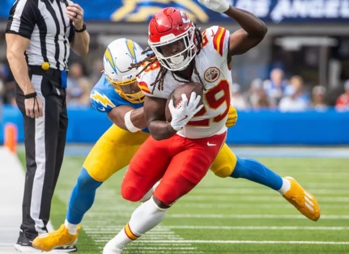 KC Chiefs running back Kareem Hunt #29 runs past LA Chargers linebacker Daiyan Henley #0 during an NFL football game at SoFi Stadium^ Aug. 17^ 2024^ in Inglewood^ Calif.