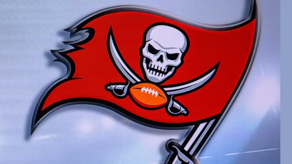 LOGO OF Tampa Bay Buccaneers. American football match^ silhouette of players.