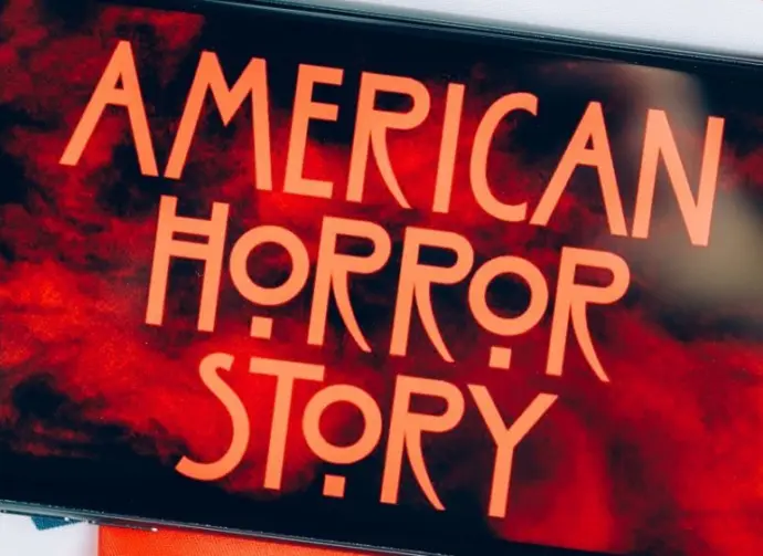 Screensaver with the 'American horror story' logo on a smartphone on toned background