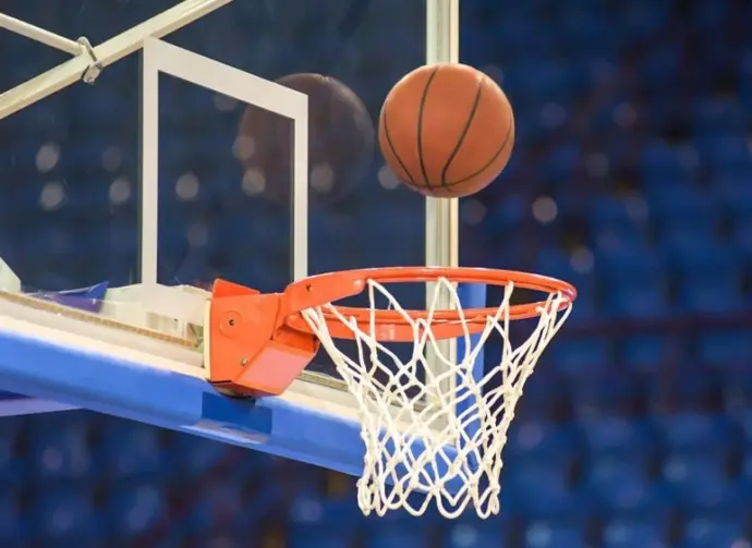 A basketball flying into the basket
