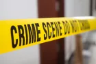 crime scene tape in front of room door with blurred background