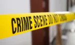 crime scene tape in front of room door with blurred background