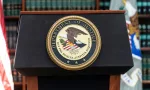 Seal of Justice Department seen during press conference at US Attorney Office library