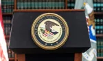 Seal of Justice Department seen during press conference at US Attorney Office library