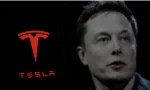 Tesla logo is displayed on smartphone screen With CEO Elon Musk in a background