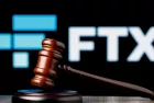 FTX is cryptocurrency exchange. Gavel on table against background of FTX logo.