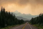 Dramatic landscape with smoke clouds along a highway in British Columbia during wildfires^ Canada.