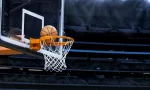 Large basketball arena; closeup of basketball going into hoop