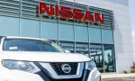 New vehicles at a Nissan Car and SUV Dealership. Nissan is part of the Renault–Nissan Alliance VII