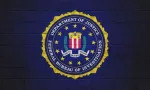 The FBI flag (Federal Bureau of Investigation) painted on a brick wall.