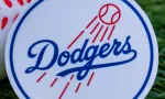 The emblem of the Los Angeles Dodgers baseball club and a baseball. September 26^ 2022^ Cooperstown^ New York