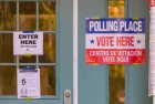 Signs on polling place door during voting on presidential election day in northern Virginia. ARLINGTON^ VIRGINIA^ USA - NOVEMBER 3^ 2020