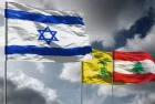 Flags of Israel above dark sky. Hezbollah and Lebanon flags in background