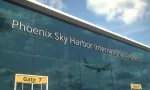 Airliner landing reflecting in the windows with phoenix sky harbor international airport text 3D rendering