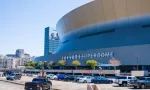 NEW ORLEANS^ LA^ USA - APRIL 3^ 2022: Superdome with parking lot and hint of the skyline during NCAA Men's Final Four Basketball Tournament