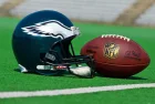 Philadelphia eagles equipment ^ ball and helmet on the green playing field ^ product shot