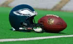 Philadelphia eagles equipment ^ ball and helmet on the green playing field ^ product shot