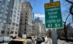 Cars driving down Fifth Avenue next to a "Toll: Congestion relief zone south of 61 Street" sign on the Upper East Side of Manhattan^ New York City New York^ NY USA - January 7^ 2025