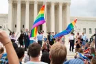 Crowd waving flags in support of LGBTQ community gathers at the U.S. Supreme Court ; WASHINGTON June 26^ 2015