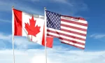 USA and Canada flags against cloudy sky. waving in the sky