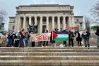 Pro-Palestinian students holding "Money Talks Strike Tuition" banner and Palestinian flag at a protest in front of Low Library on the Columbia University campus New York^ NY USA - January 19^ 2024