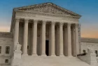 Greek classical architecture of the United States Supreme Court building with sunrise in background.
