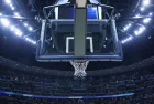 Brightly lit Basketball backboard in a large sports arena.