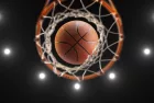 3d rendering basketball on hoop and lighting from roof stadium