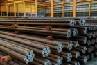 Rows of Steel Round Bar storage and stacking in the warehouse for industrial construction.