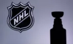 National Hockey LeagueLogo of NHL club on the screen. Stenley Cup Trophy Silhouette.