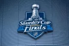 the front facade of a hockey arena with the NHL Stanley Cup Finals logo on the front of the building.