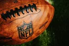 NFL background photo. Ball placed on green grass in beautiful light. NEW YORK^ USA^ SEPTEMBER 11^ 2023
