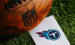 Tennessee Titans NFL team Logo and American football ball on Green Grass. TENNESSEE^ USA^ FEBRUARY 10^ 2025