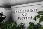 Silver sign of Department of Justice on a classical concrete wall with plants as foreground. 3D illustration of the concept of enforcement of federal laws