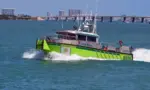 Miami-Dade fire-rescue boat patrolling on Biscayne Bay with Julia Tuttle causeway bridge in the distant background. Miami Beach^Florida^U.S.A. 13 March2021