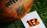 Cincinnati Bengals NFL team Logo and American football ball on Green Grass. CINCINNATI^ USA^ FEBRUARY 10^ 2025