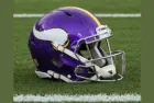 NFL's Minnesota Vikings helmet placed on football field - AI GENERATED IMAGE