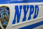 Side door closeup of Nypd police patrol car are patrolling parked near the curb. New York november 2020