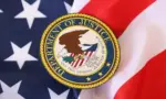 US Department of Justice seal on United States of America flag close up