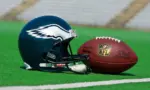Philadelphia eagles equipment ^ ball and helmet on the green playing field ^ product shot AUGUST 13^ 2015